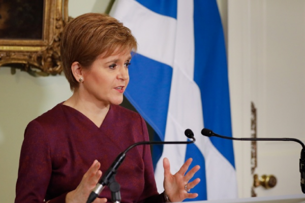 Nicola Sturgeon, First Minister of Scotland, speaking at a podium in Bute House